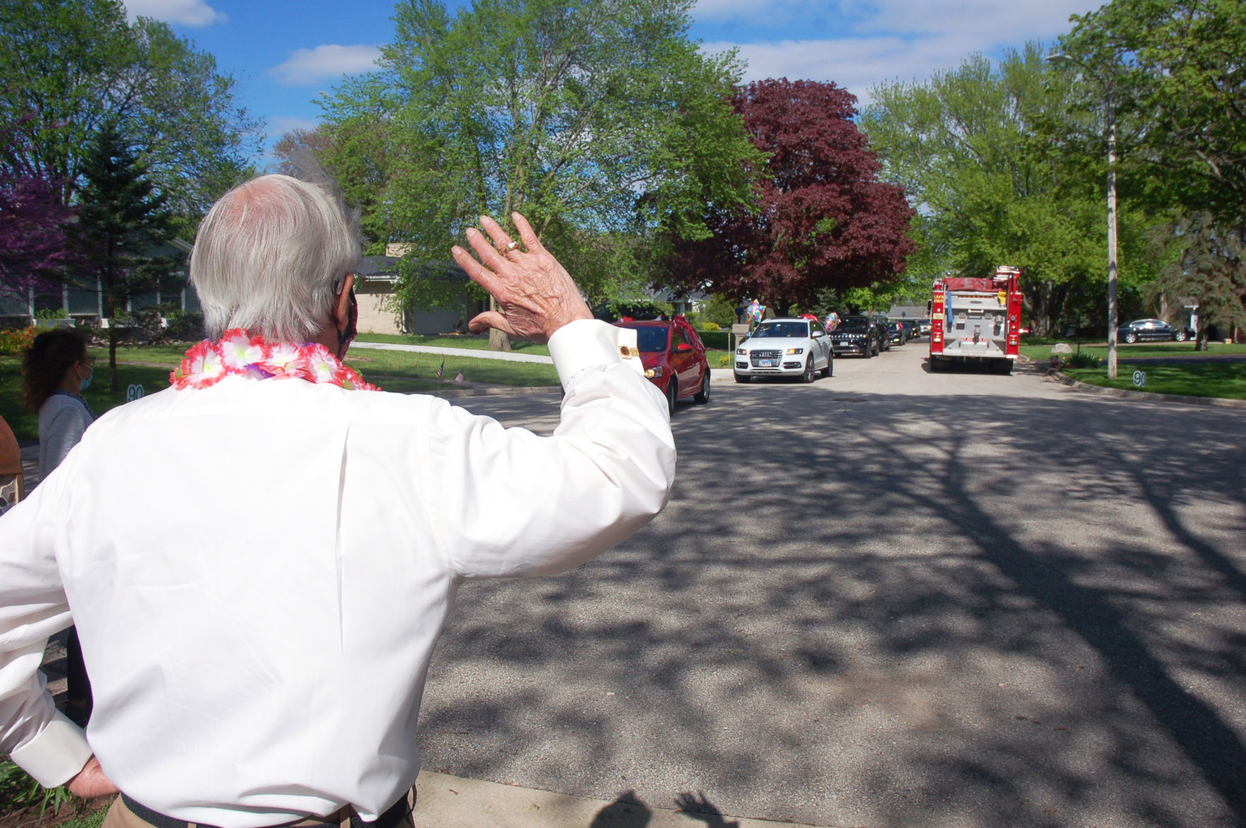 Gene Haseley greets parade on his cul-de-sac